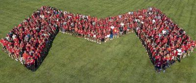 On-campus students at Maryville University stand in Big Red M formation